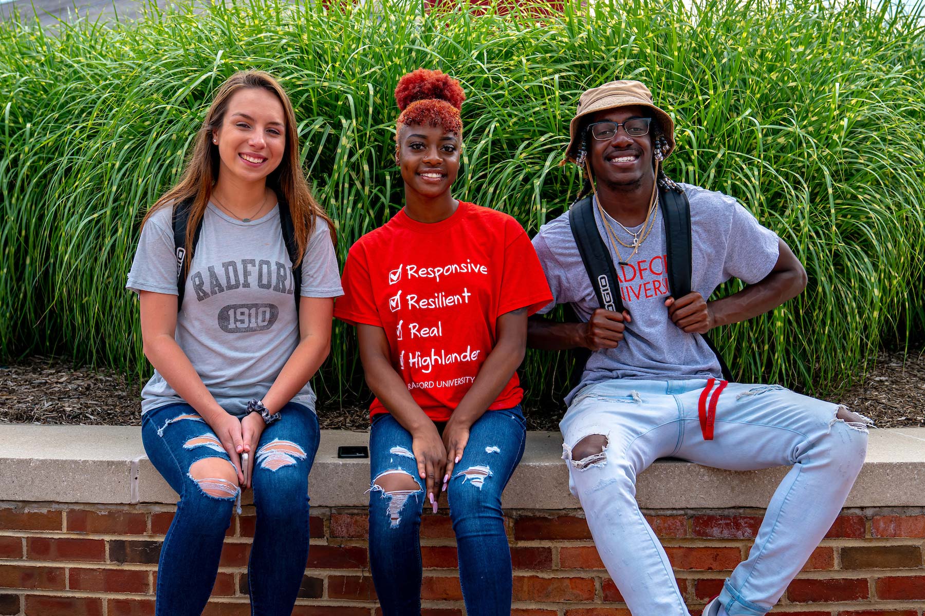 students in front of red clocks