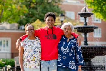 student with family at fountain
