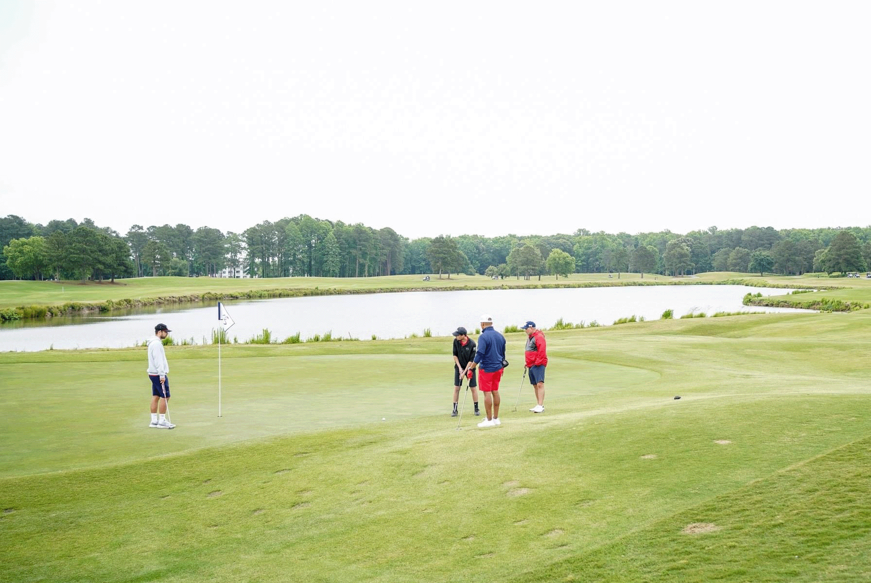 Four golfers standing on the green at Virginia Beach National Golf Club