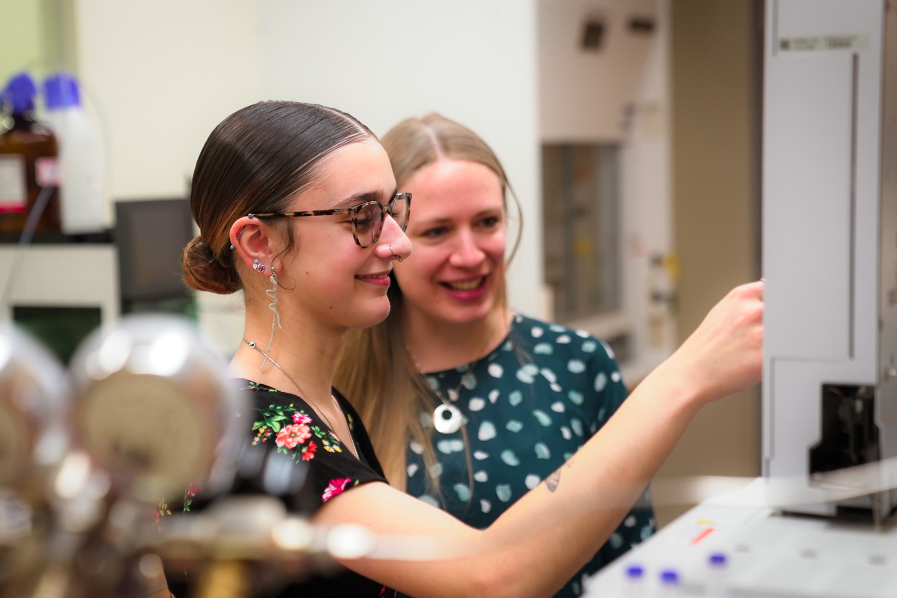 student and professor in research lab