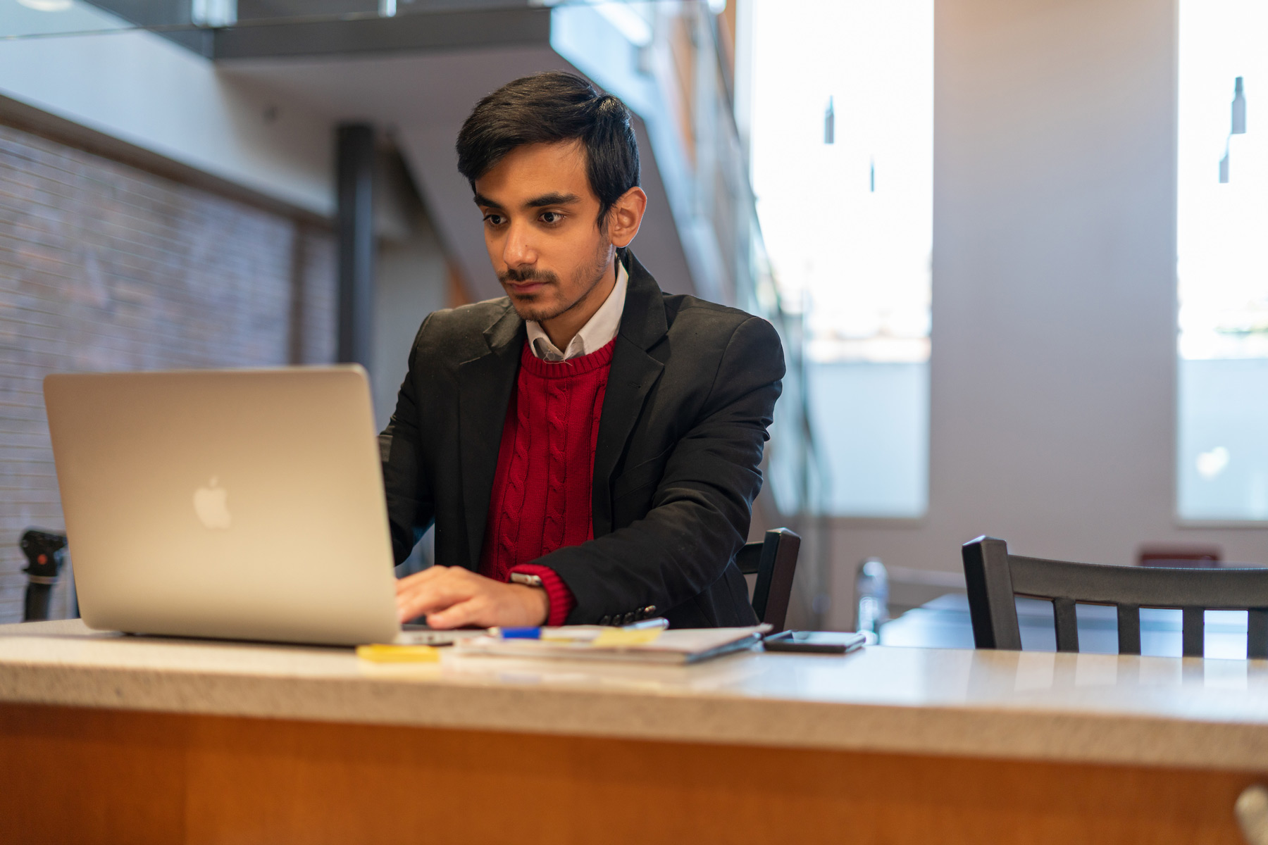 young man on laptop at desk