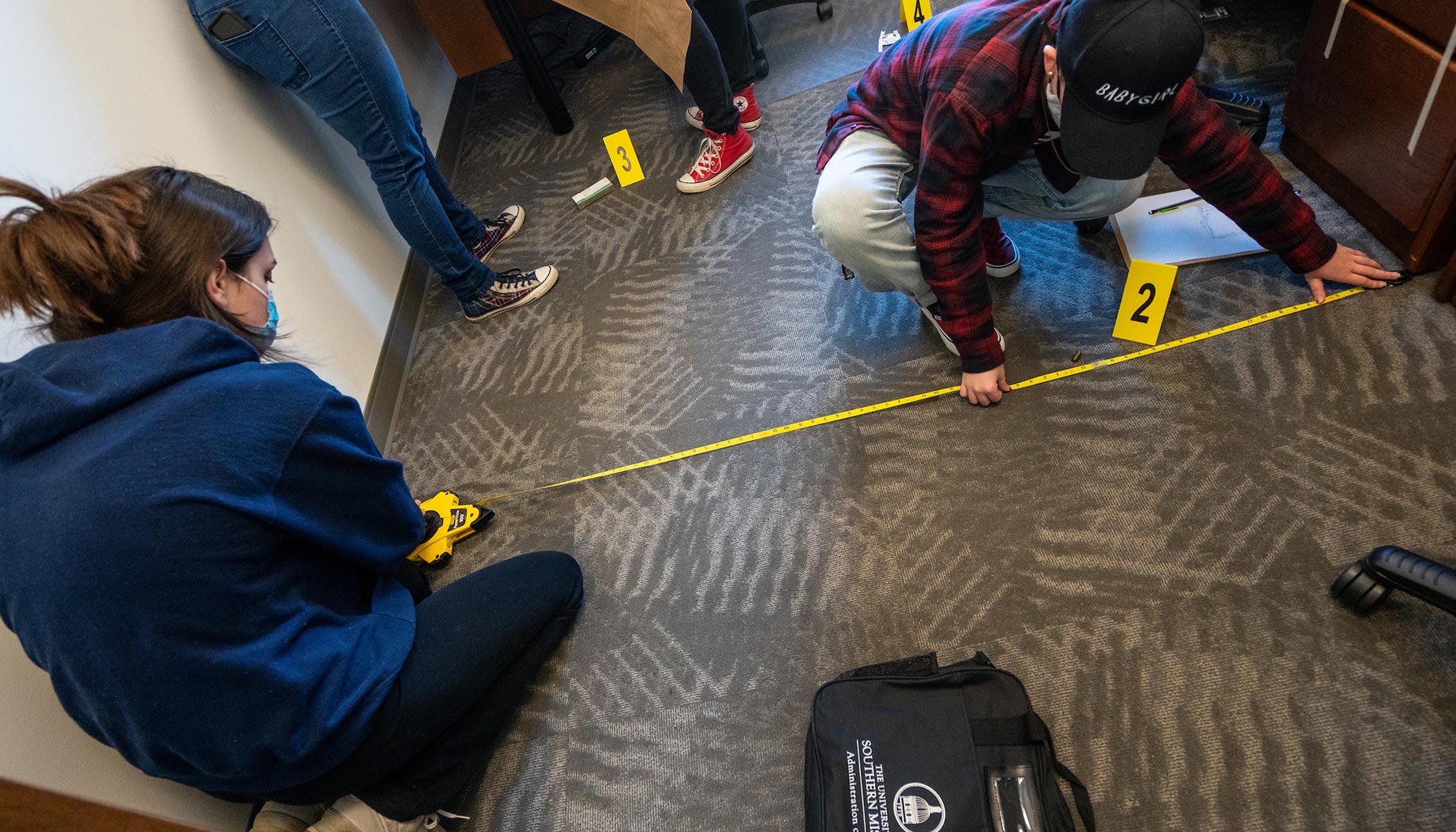 criminal justice students during a mock crime scene lab