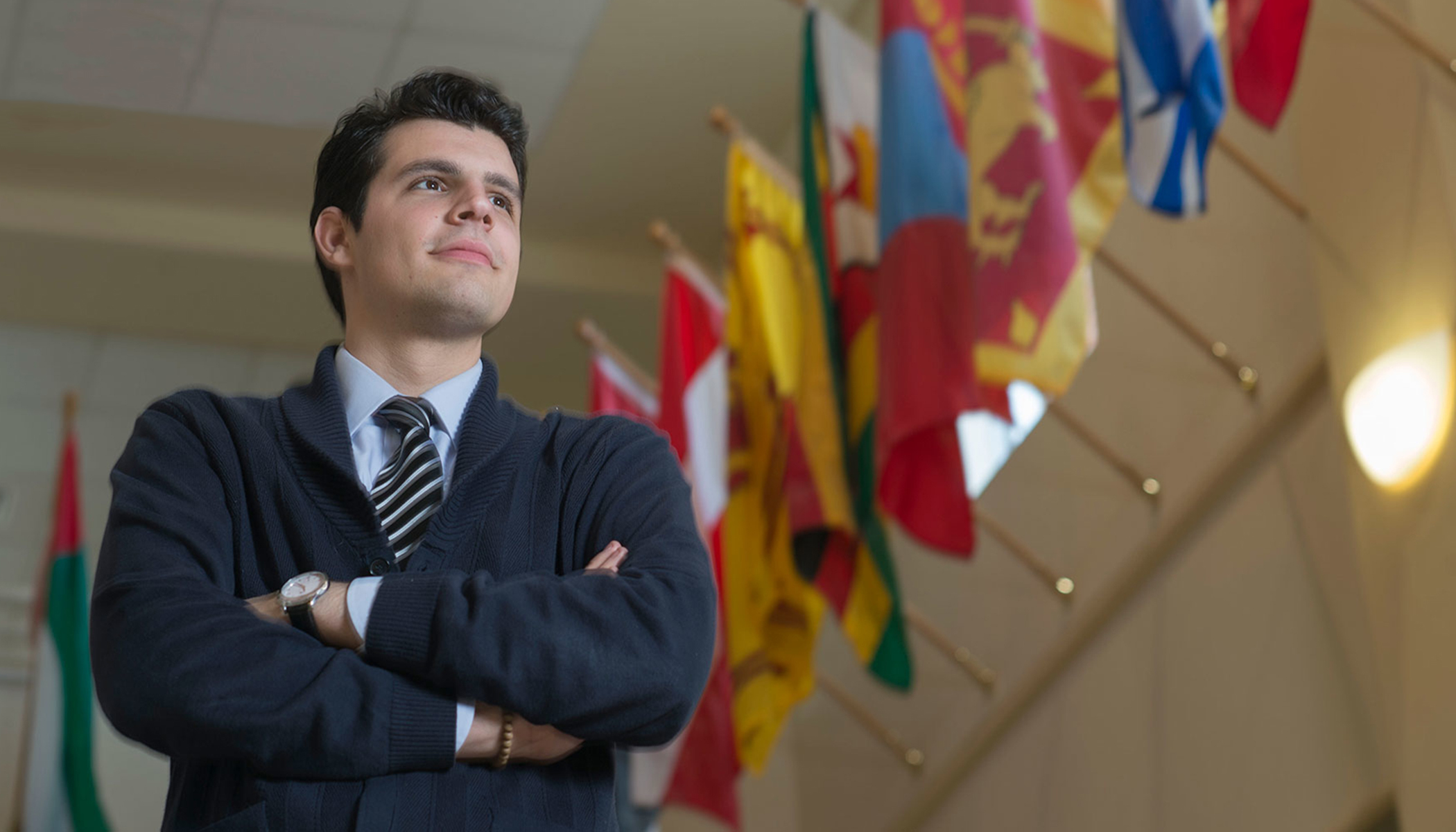 Student in front of flags