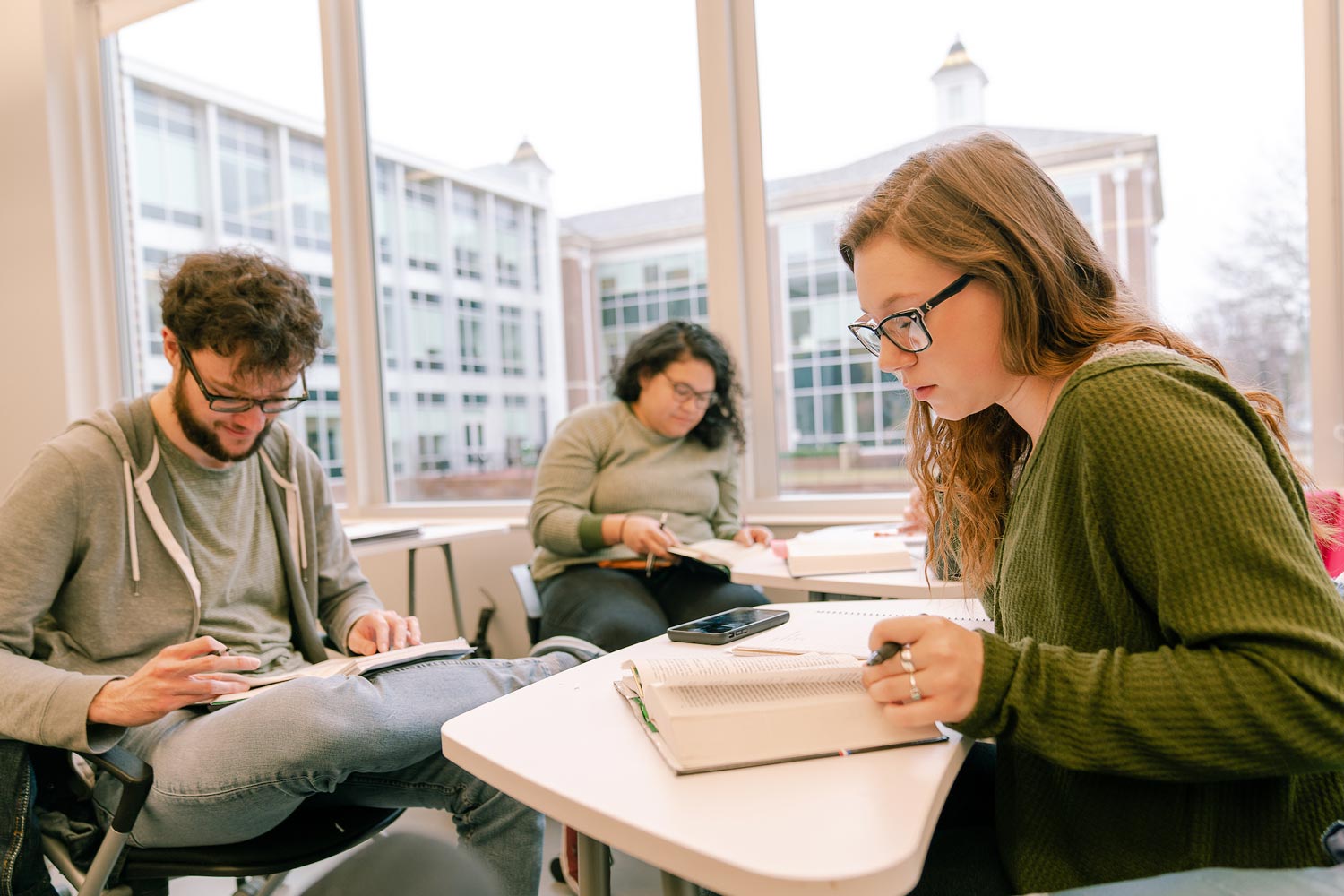 students reading a book in class