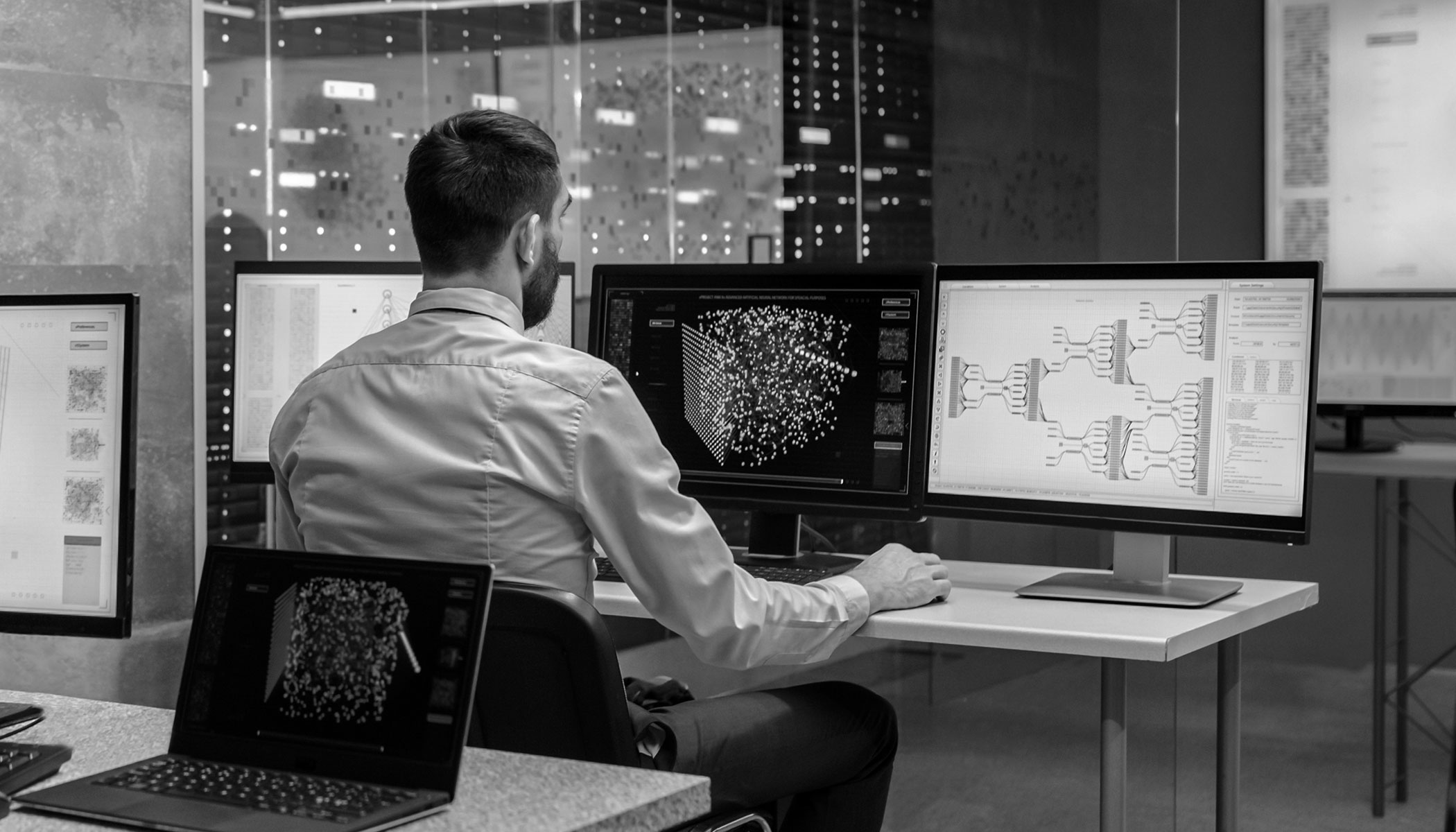 man working behind a computer screen