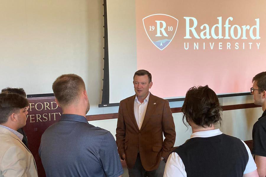 Entrepreneur Jason Adkins MBA '98 chats with Radford business students at the end of his guest lecture.