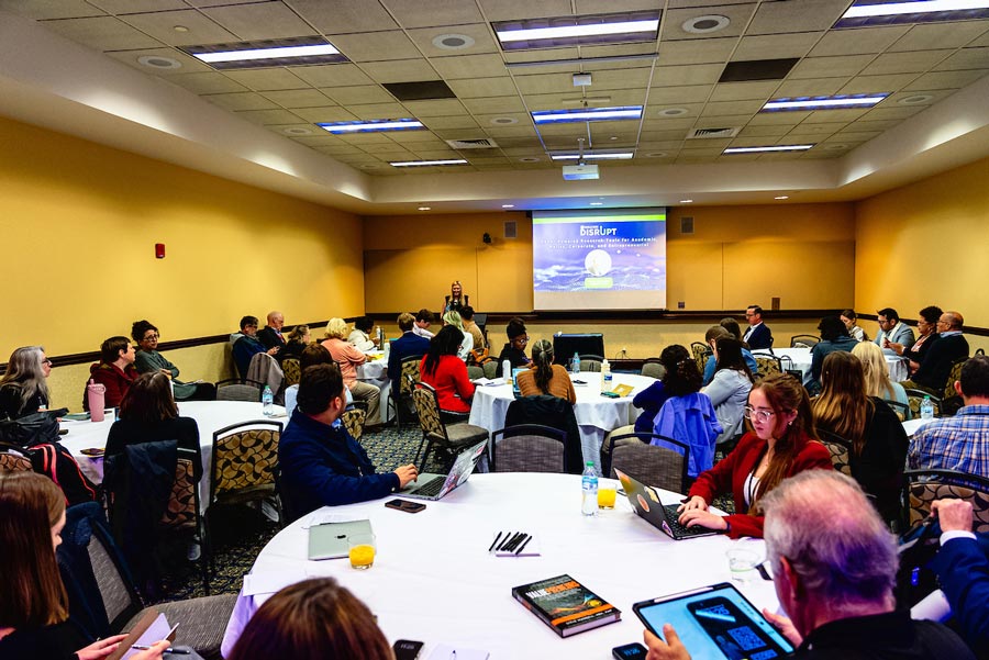 people in a conference room listen to a discussion about AI