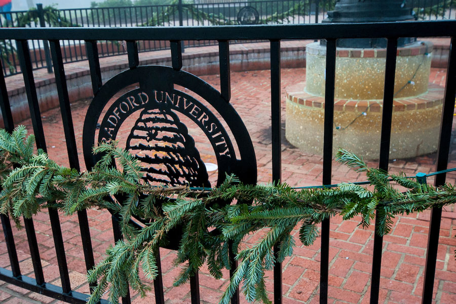 The Radford University seal, part of the fence that circles the campus fountain, is decorated with a holiday branch.