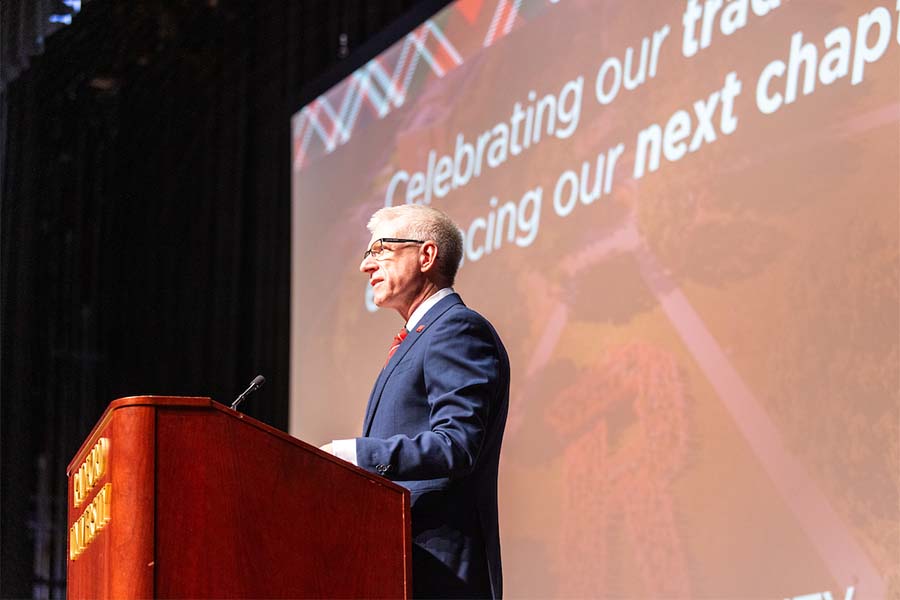 Radford University's president Bret Danilowicz stands at a podium and delivers his homecoming address.