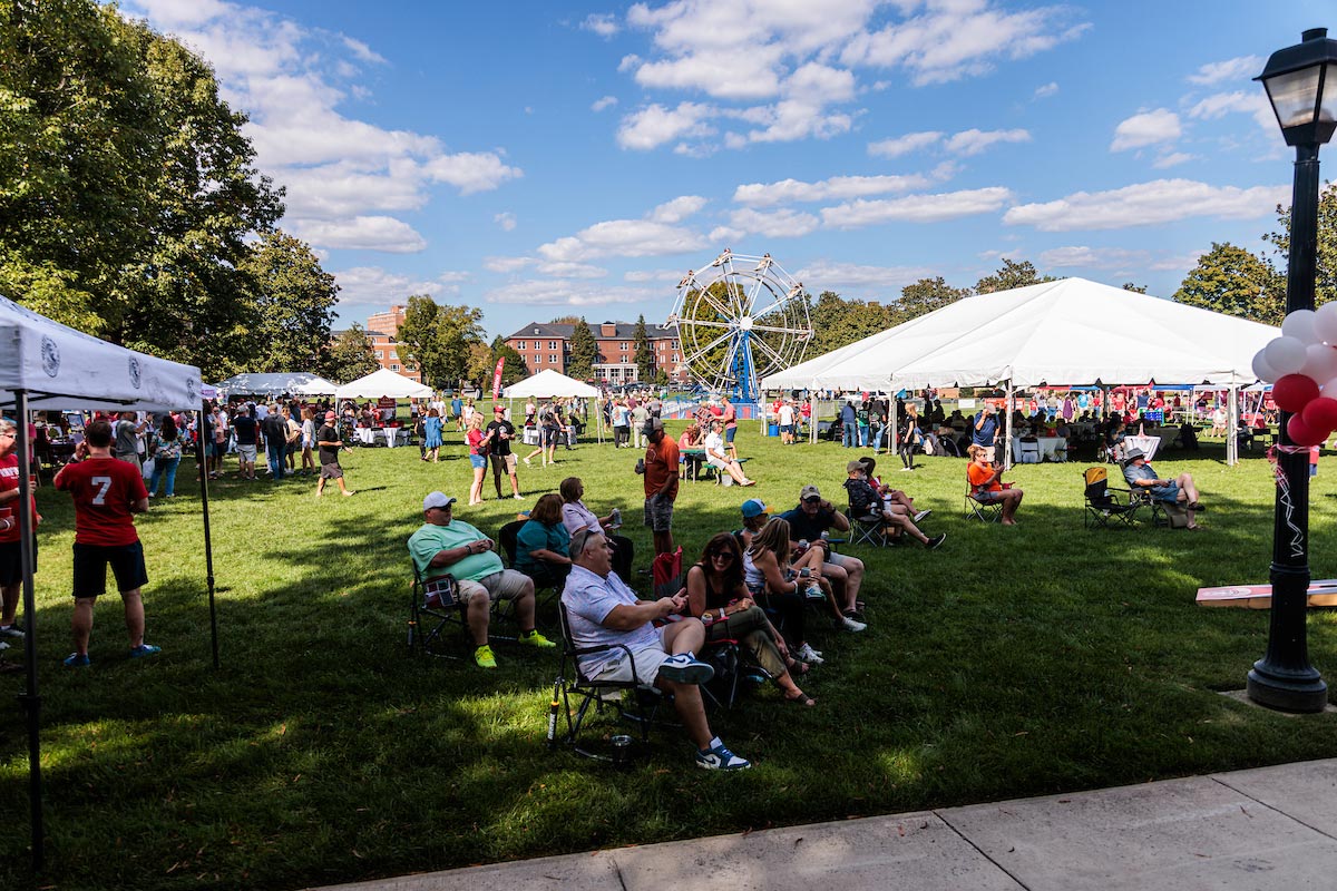 A campus lawn party on a sunny day is enjoyed by Radford University alumni who returned to campus for Homecoming.