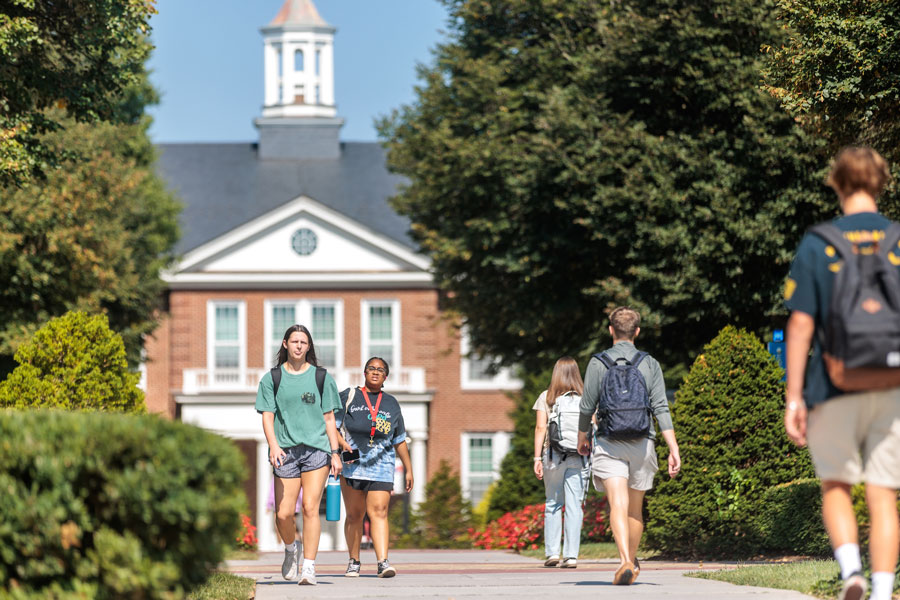 Radford University students walk in front of Whitt Hall during class changeover on Aug. 26, 2024. 