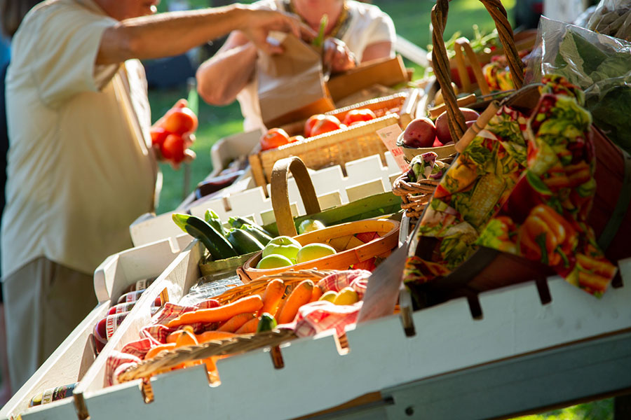 People purchasing vegatables at a farmer's market