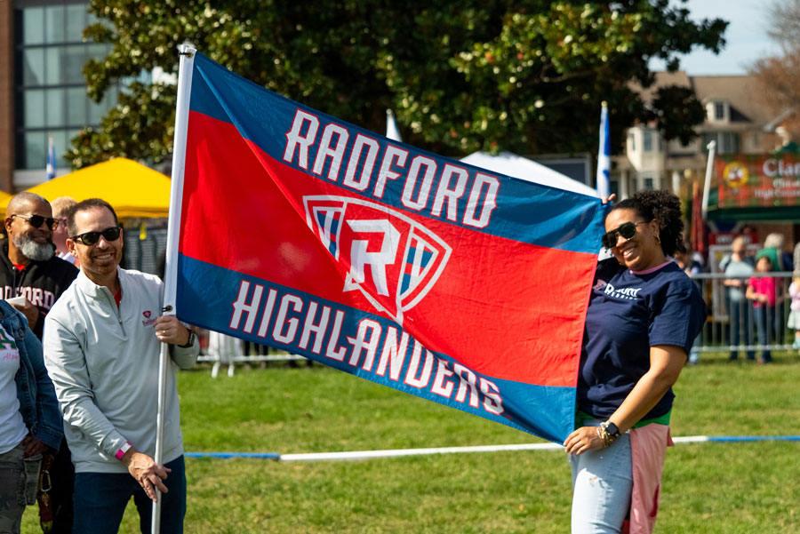 alumni holding flag during homecoming