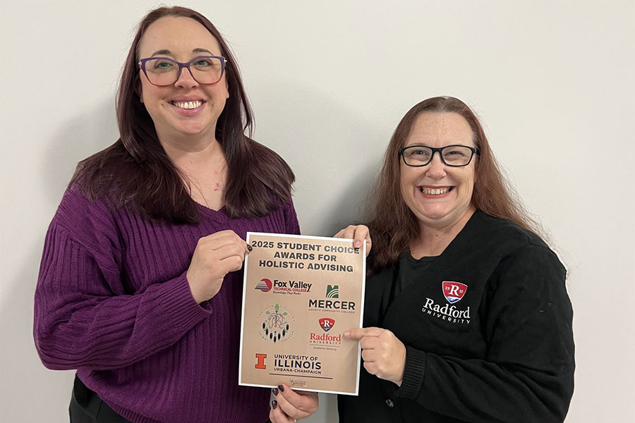 Academic Advising staff pose with award poster