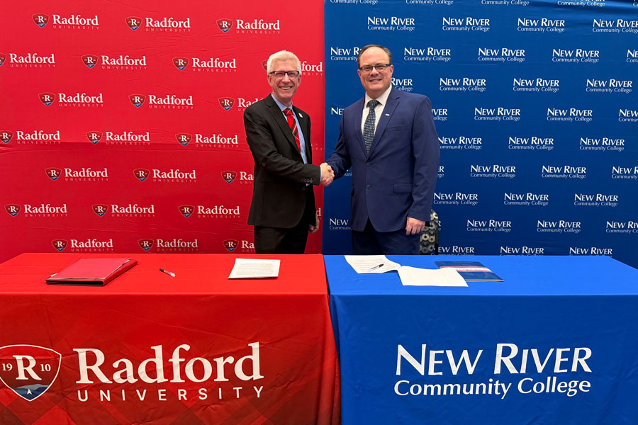 Presidents from both institutions shaking hands