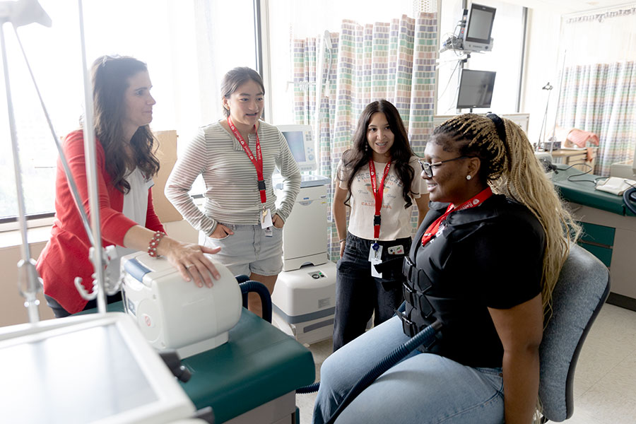Governor’s School students test a machine to help open airways with Radford respiratory therapy program faculty.