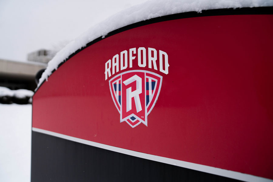 Snow covering a Radford University Athletics sign