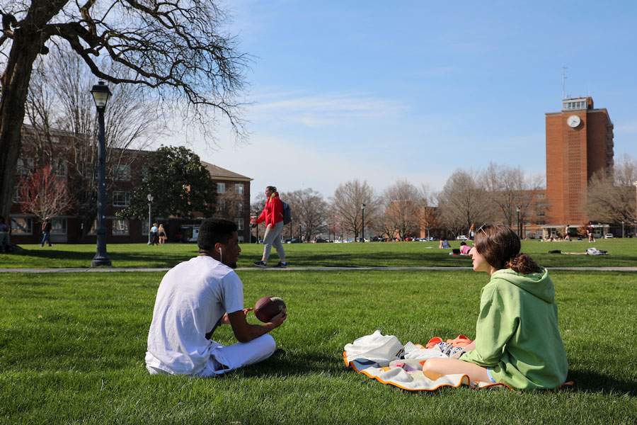 Two students enjoy Radford University's campus during springtime.