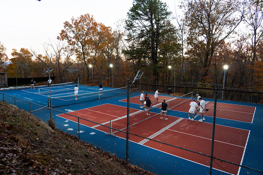 Radford University students play pickleball on a court.