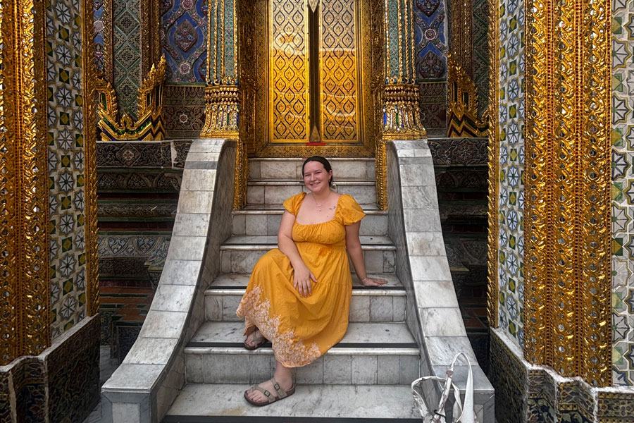Radford University student sitting on stairs in Thailand