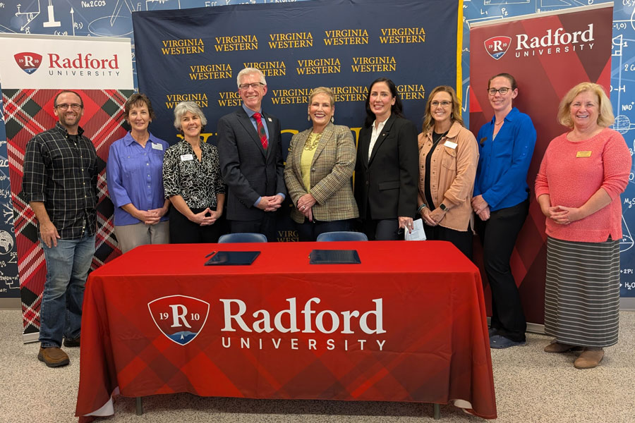 signing event including leaders from both institutions