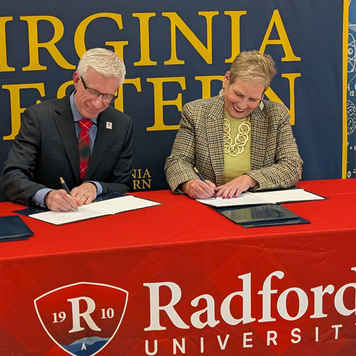 presidents from both institutions signing documents
