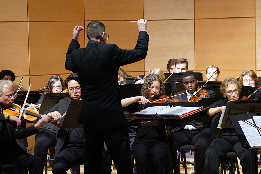 Dr. Wayne Gallops conducting the University Community Symphony.