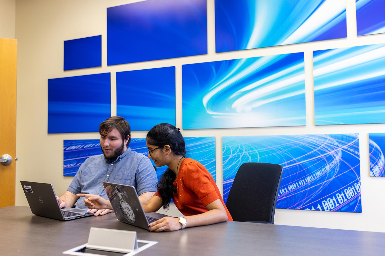 students sitting with computer