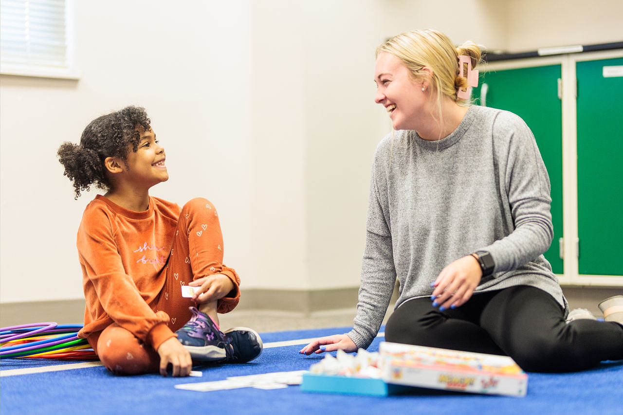 adult and child on a play mat