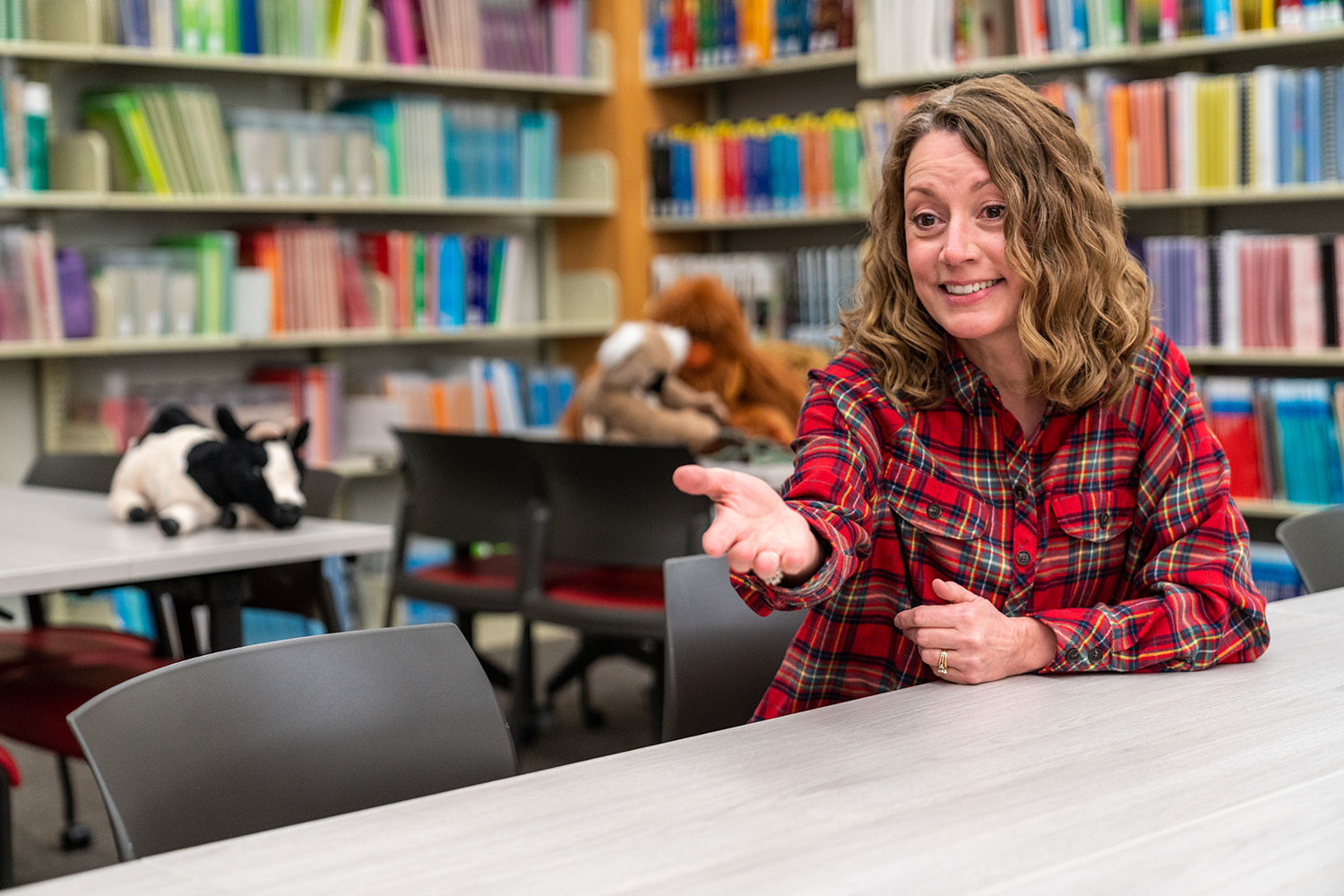 student smiling and pointing