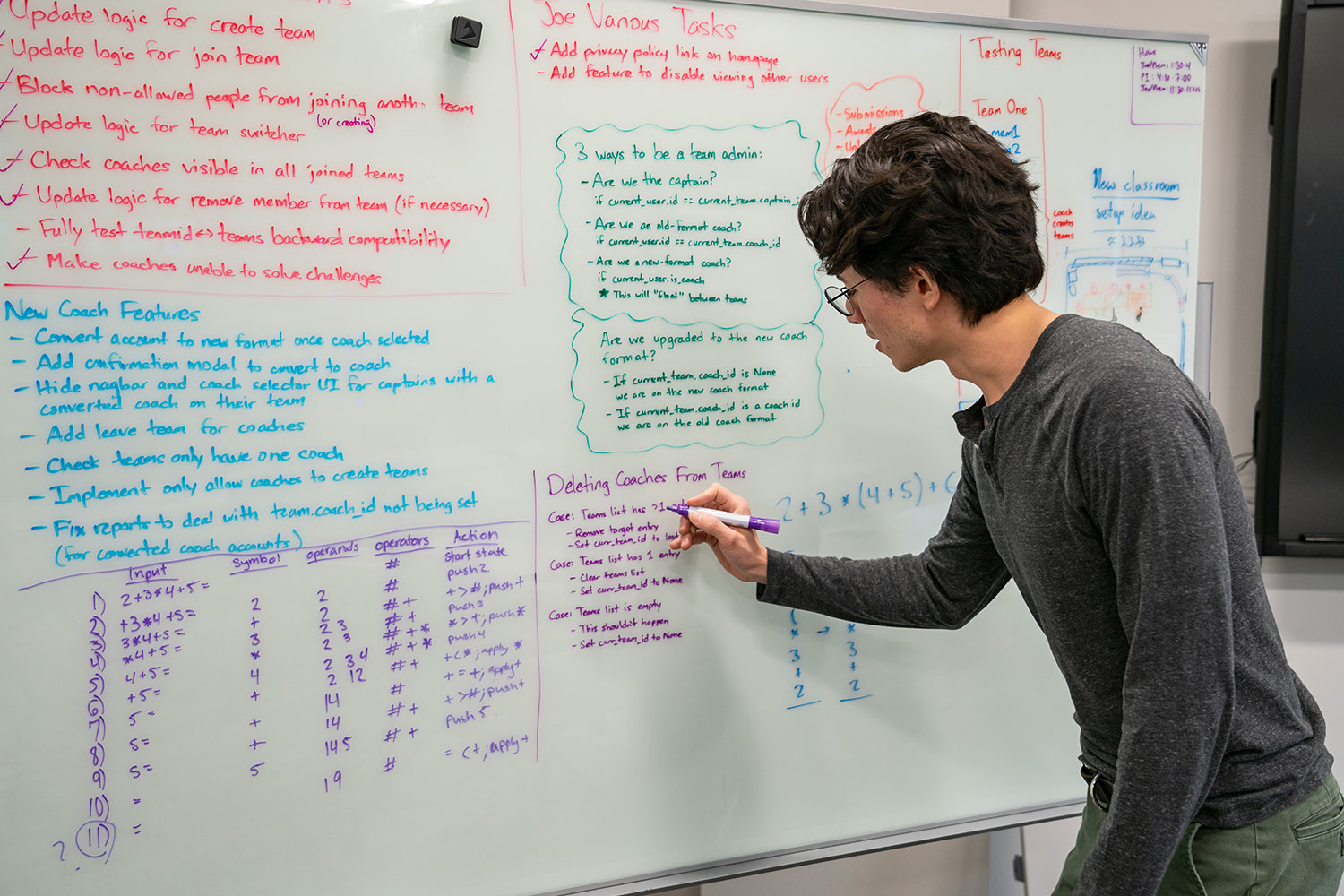 boy writing on whiteboard