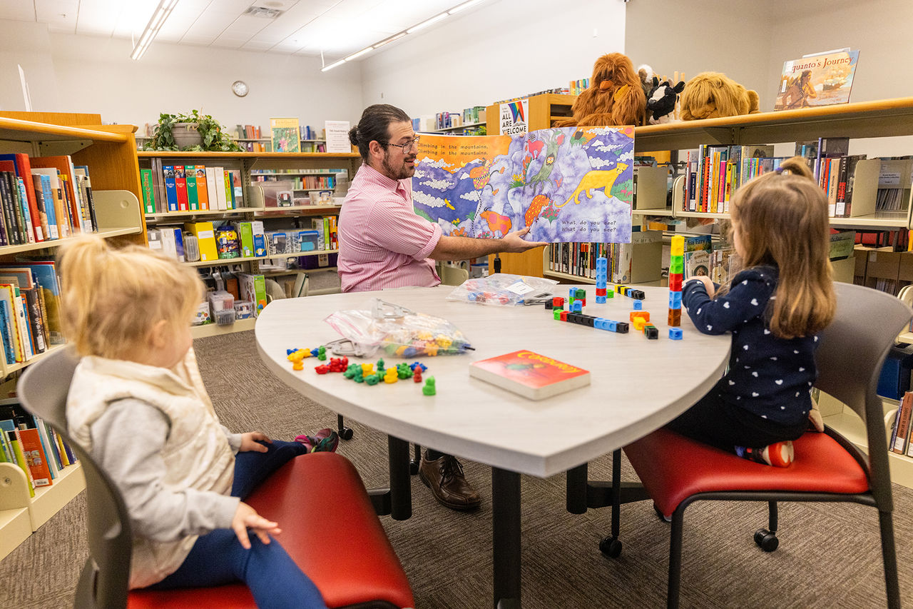 teacher showing students a picture book