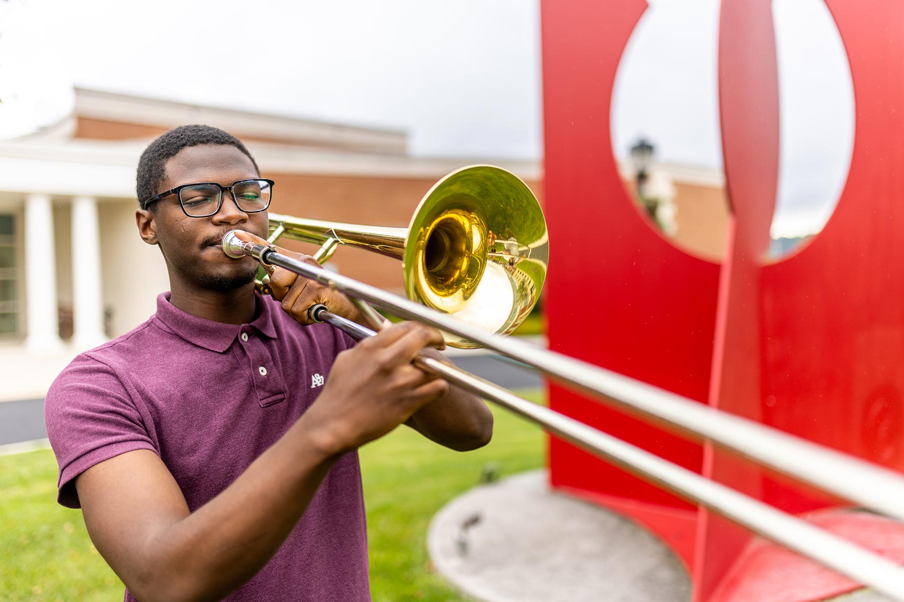 a male playing the trombone