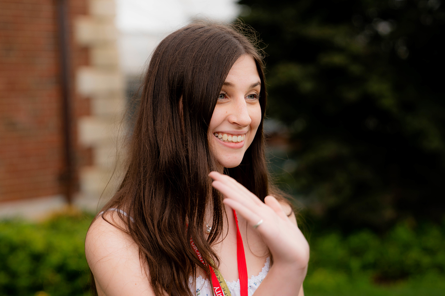 Excited student waving to another student