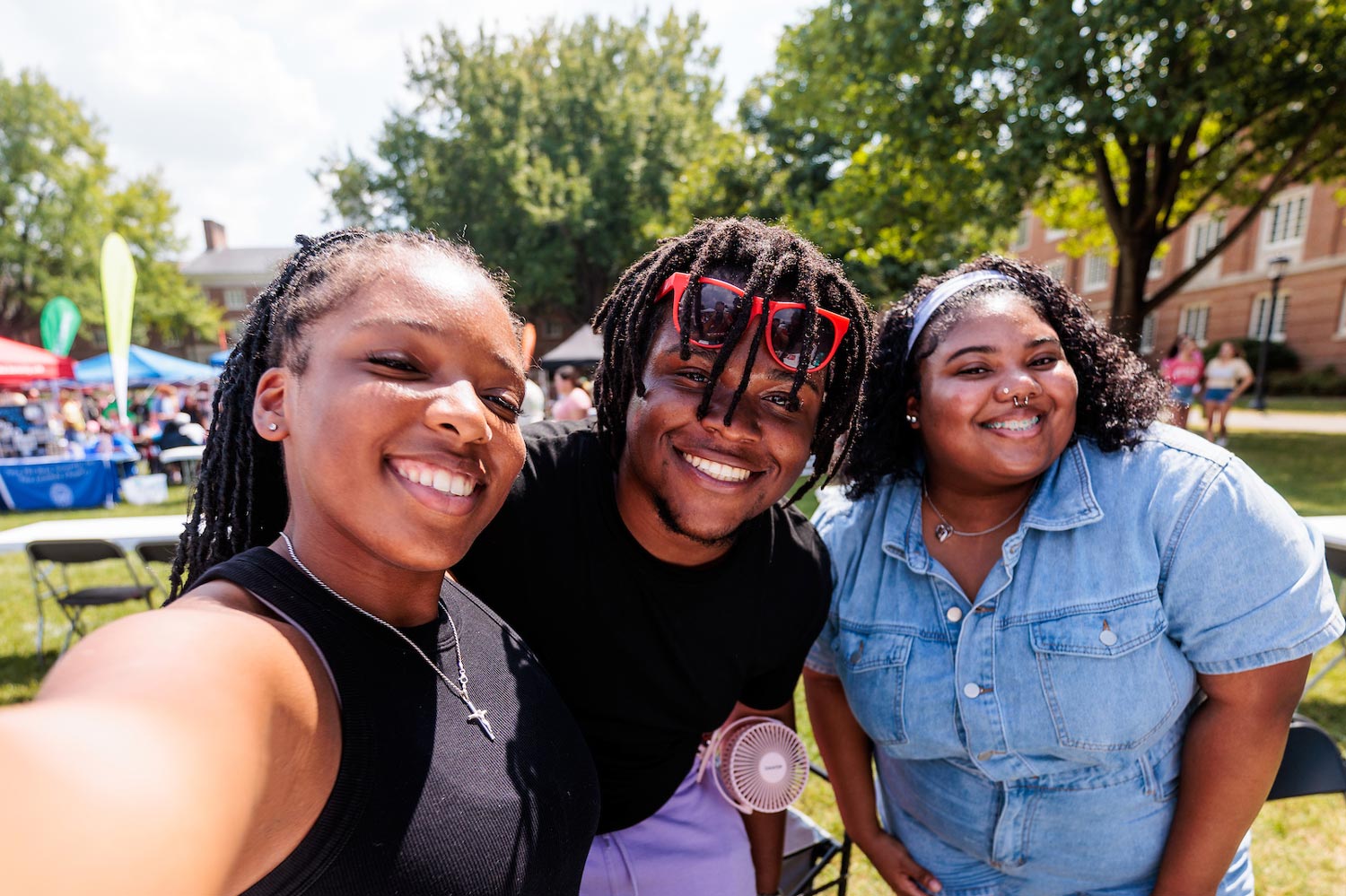 students smiling for camera at club fair