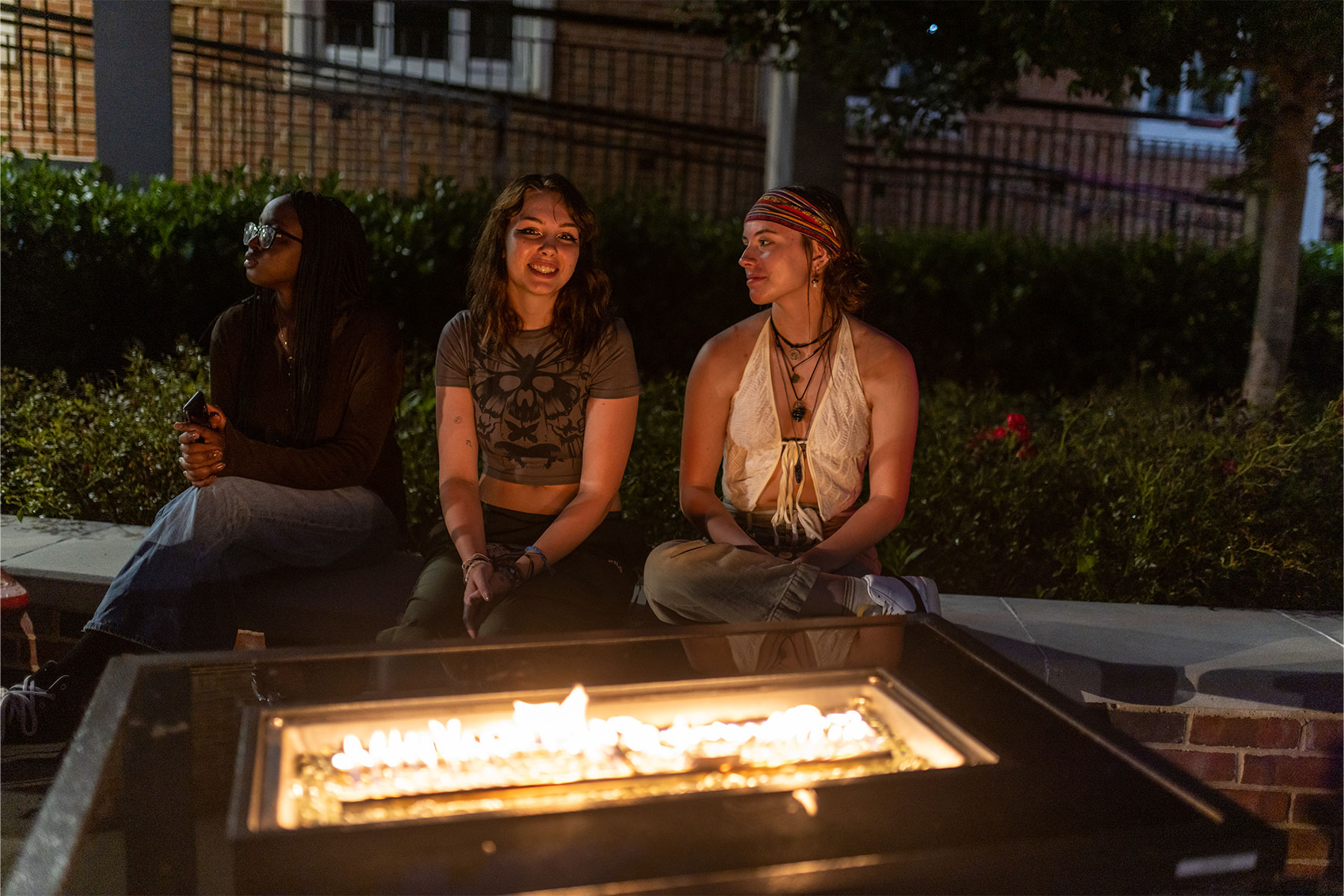 students by a fire in front of the Bonnie student center