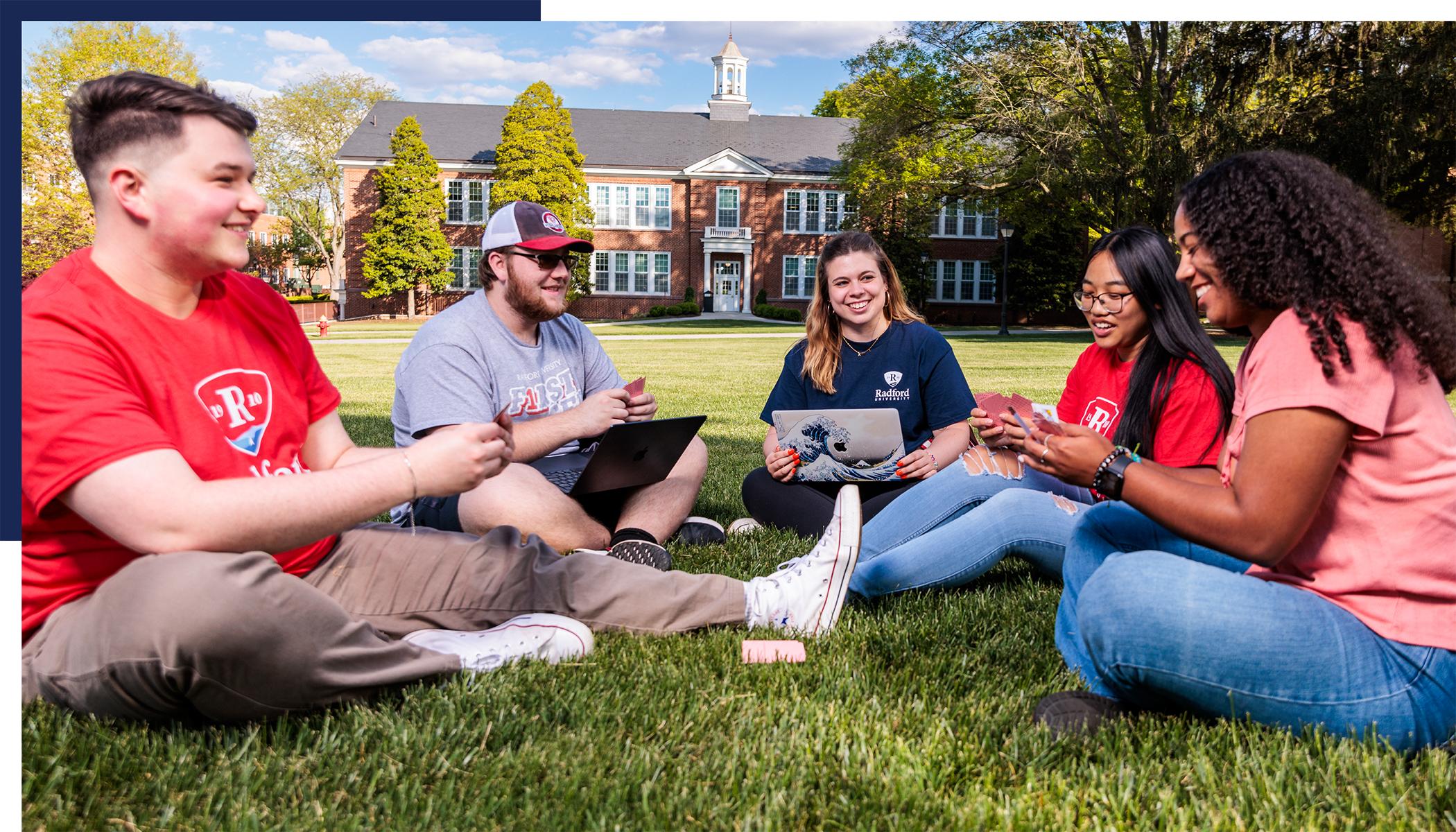 group of students playing cards on campus