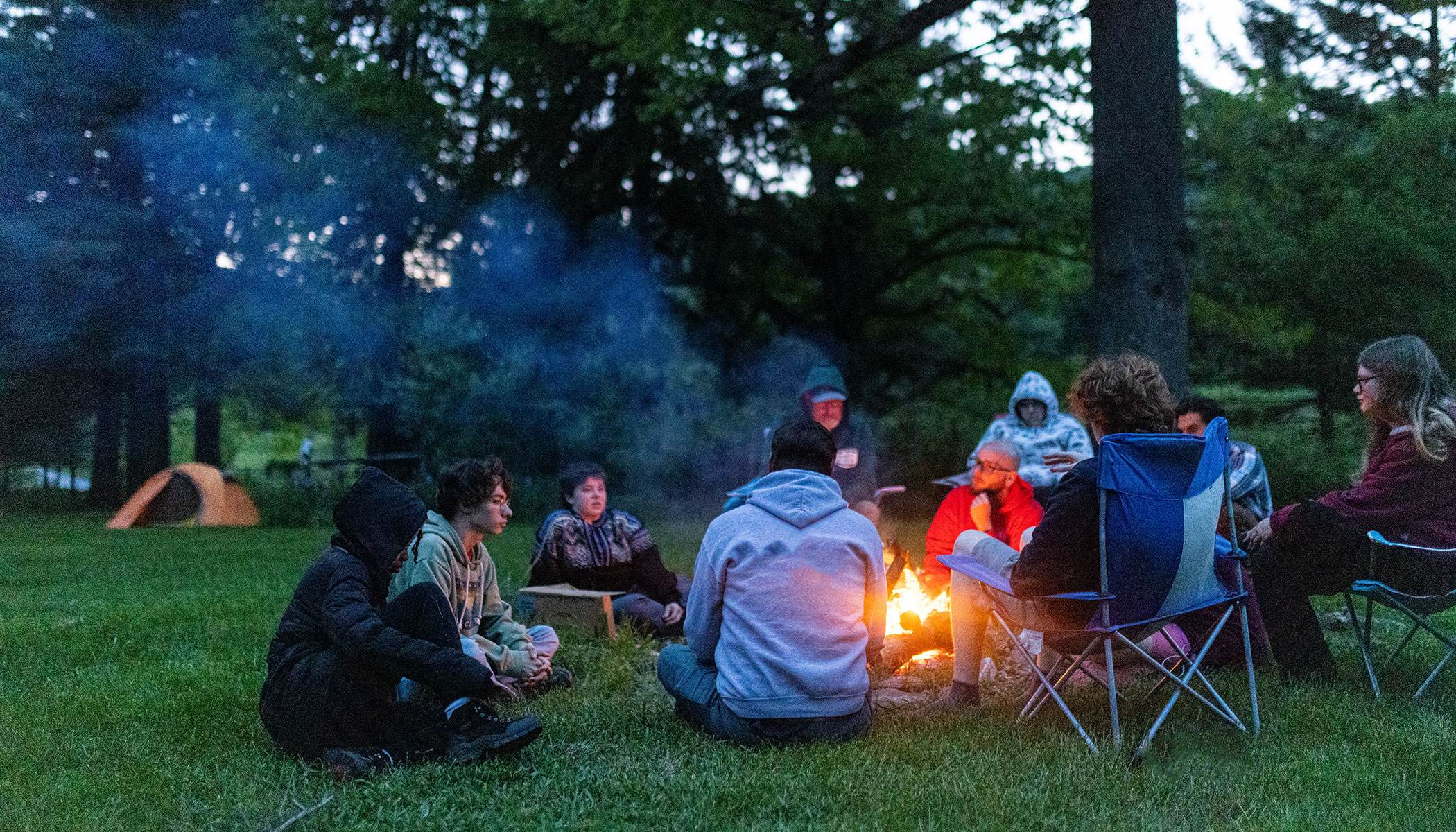 Students sitting around a fireside chat.