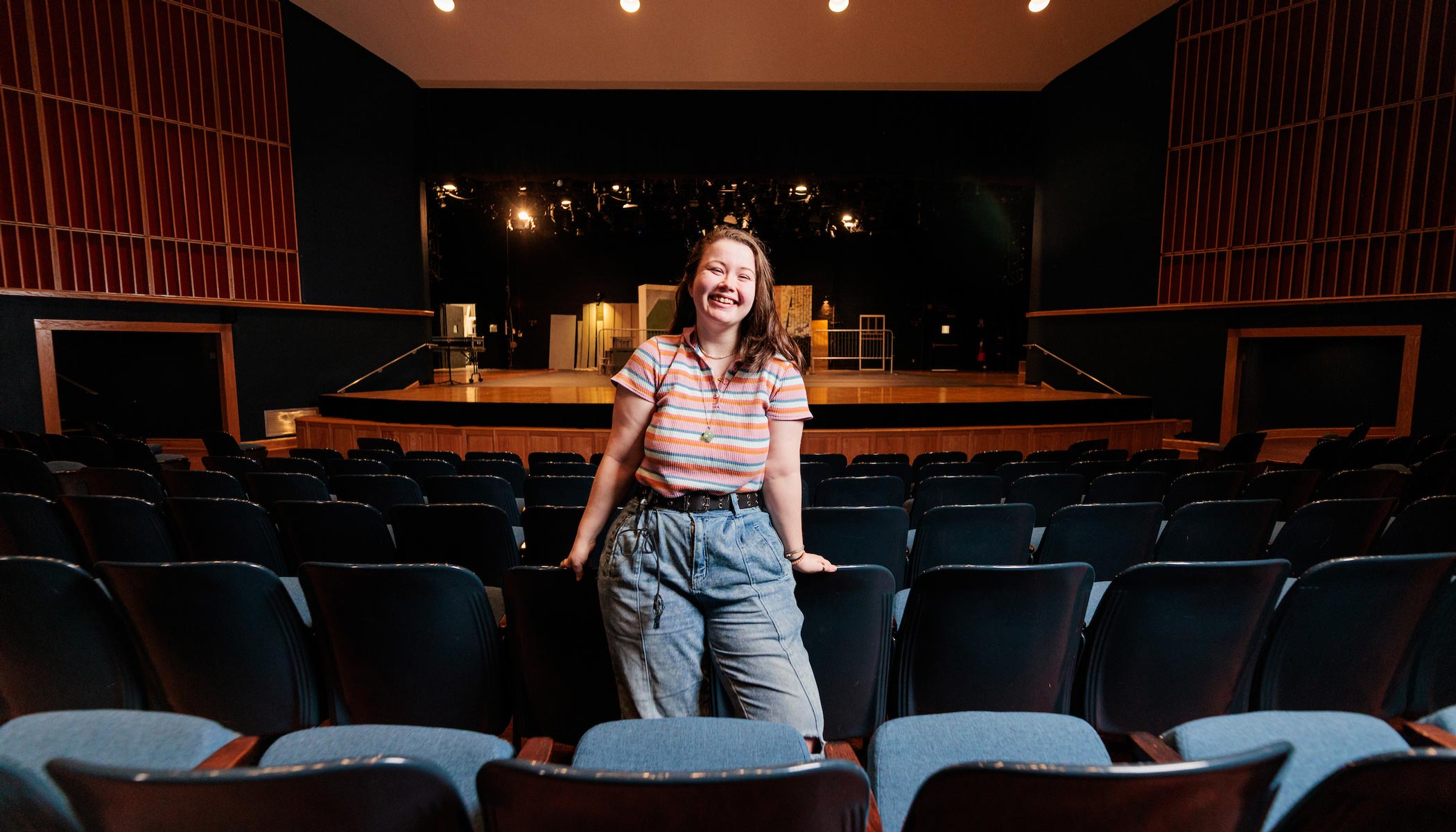 theatre student in empty performance auditorium