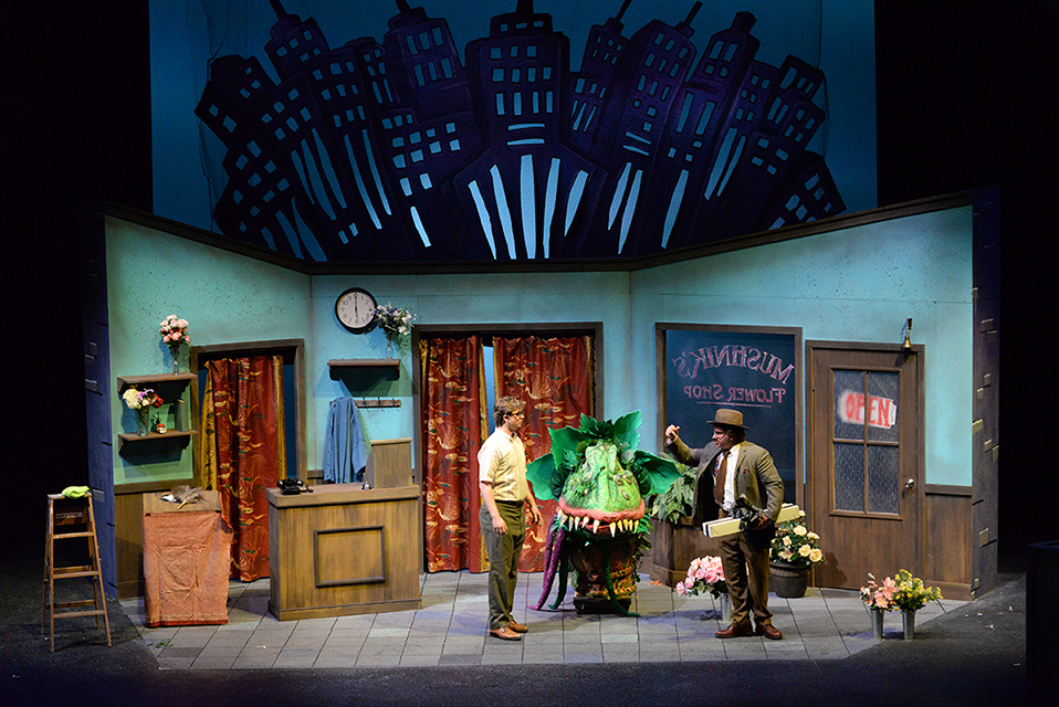 Performers on stage in a production of Little Shop of Horrors